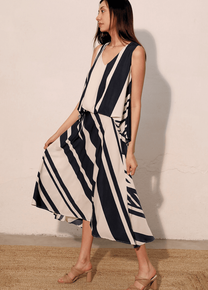Effortlessly versatile, the Sienna Stripe Midi Swing Skirt delivers timeless appeal with its classic black and ivory vertical stripes. The flowing midi silhouette flatters all body types while the lightweight fabric and elastic waistband ensure comfort from morning through evening Paired with Effortless sophistication meets everyday comfort in this sleeveless striped top. The classic black and ivory stripe pattern pairs with a flattering V-neckline, while strategic front gathering creates the polished look 
