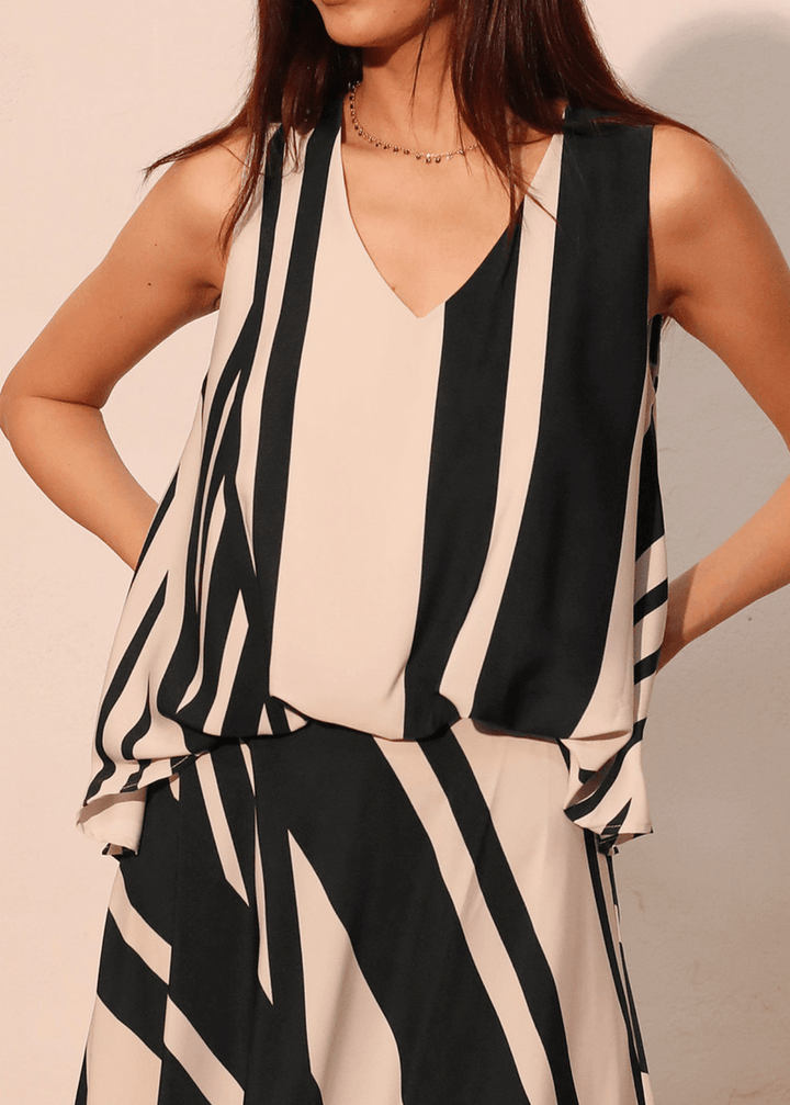 Effortless sophistication meets everyday comfort in this sleeveless striped top. The classic black and ivory stripe pattern pairs with a flattering V-neckline, while strategic front gathering creates the polished look of a tucked-in style. Made in USA