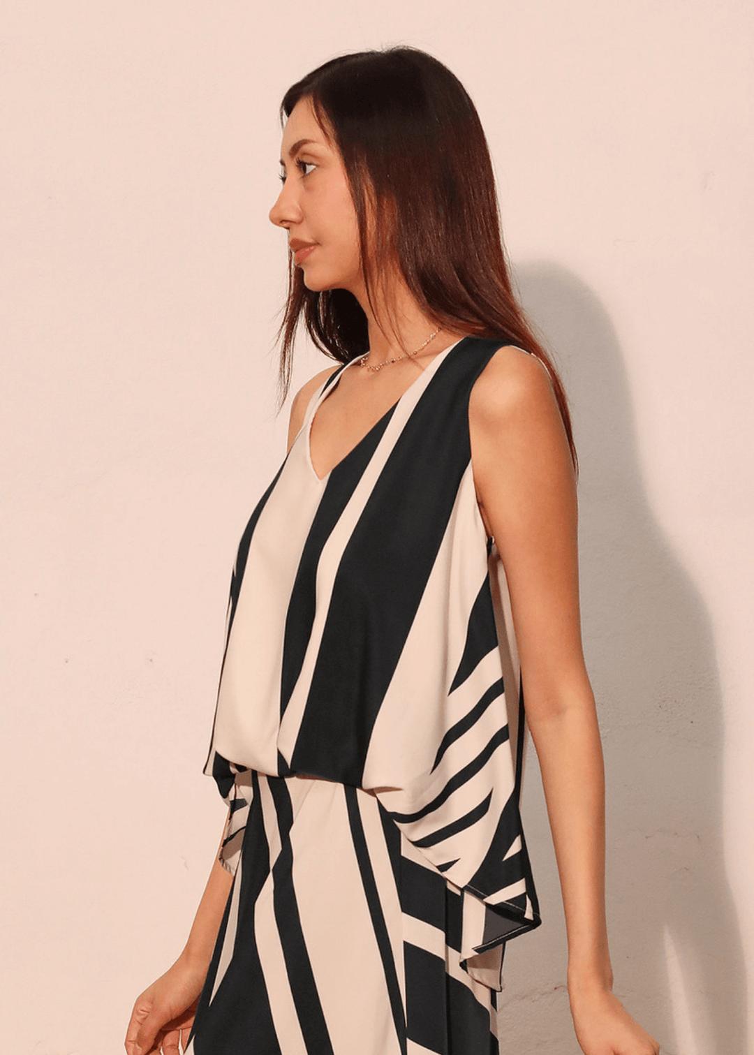 Effortless sophistication meets everyday comfort in this sleeveless striped top. The classic black and ivory stripe pattern pairs with a flattering V-neckline, while strategic front gathering creates the polished look of a tucked-in style. Made in USA