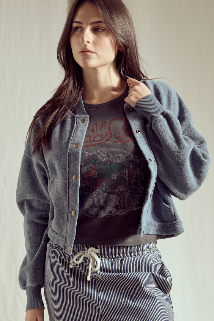 Shop the Sundown Jacket by People of Leisure — an oversized 100% organic fleece jacket with pockets, bold buttons &amp; drawstring waist. In Vintage Black &amp; Navy. Sizes XS–XL.