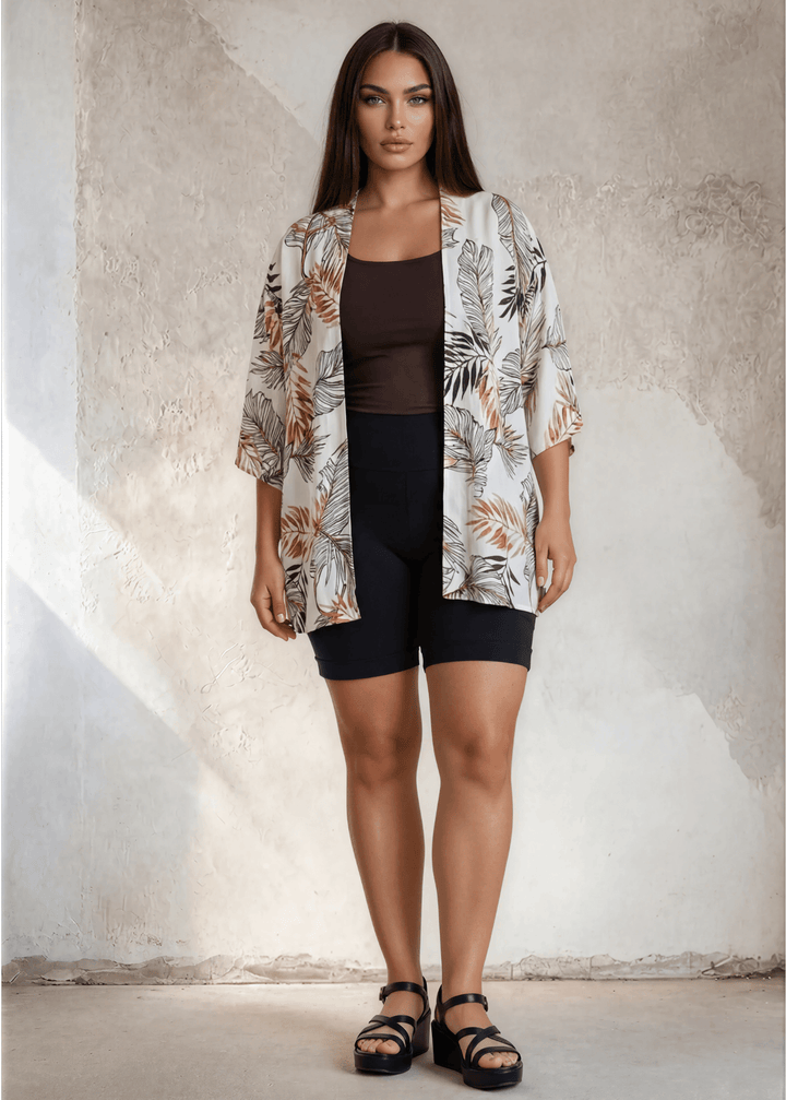 Flowy earth tone tropical floral kimono with short sleeves. Open front, relaxed fit, 95% polyester. Plus sizes 1X-3X. Made in USA. Perfect beach cover-up.