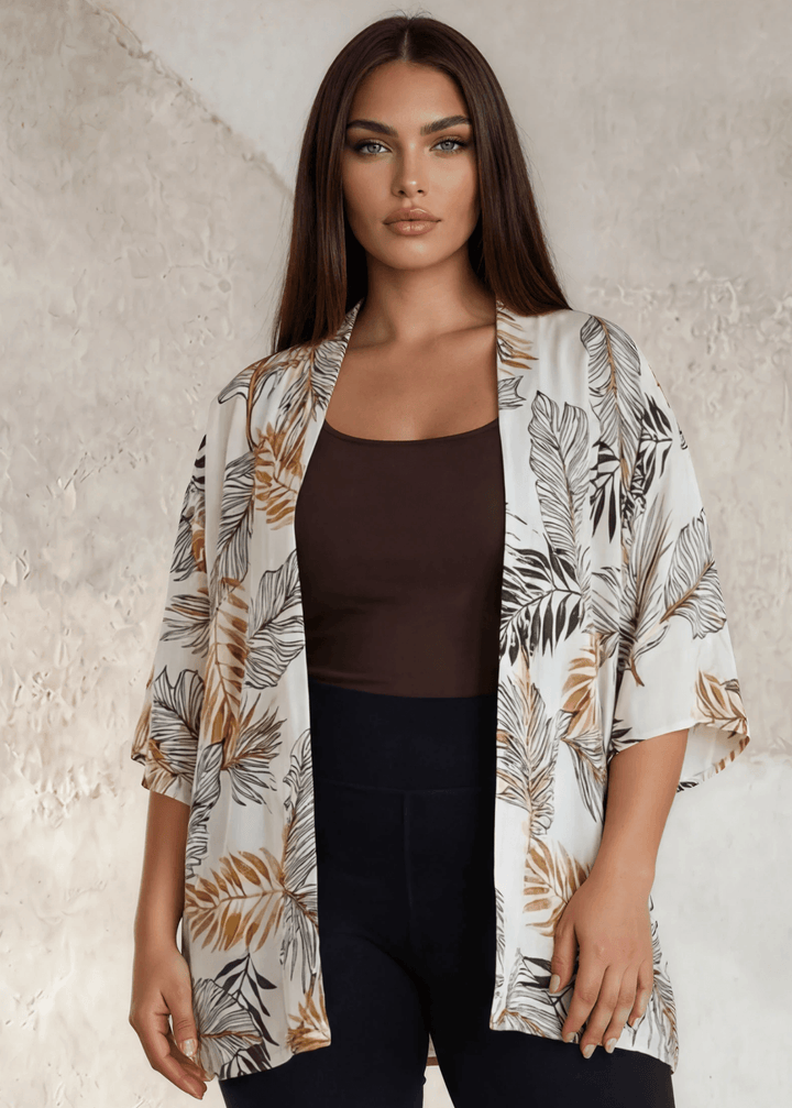 Flowy earth tone tropical floral kimono with short sleeves. Open front, relaxed fit, 95% polyester. Plus sizes 1X-3X. Made in USA. Perfect beach cover-up.