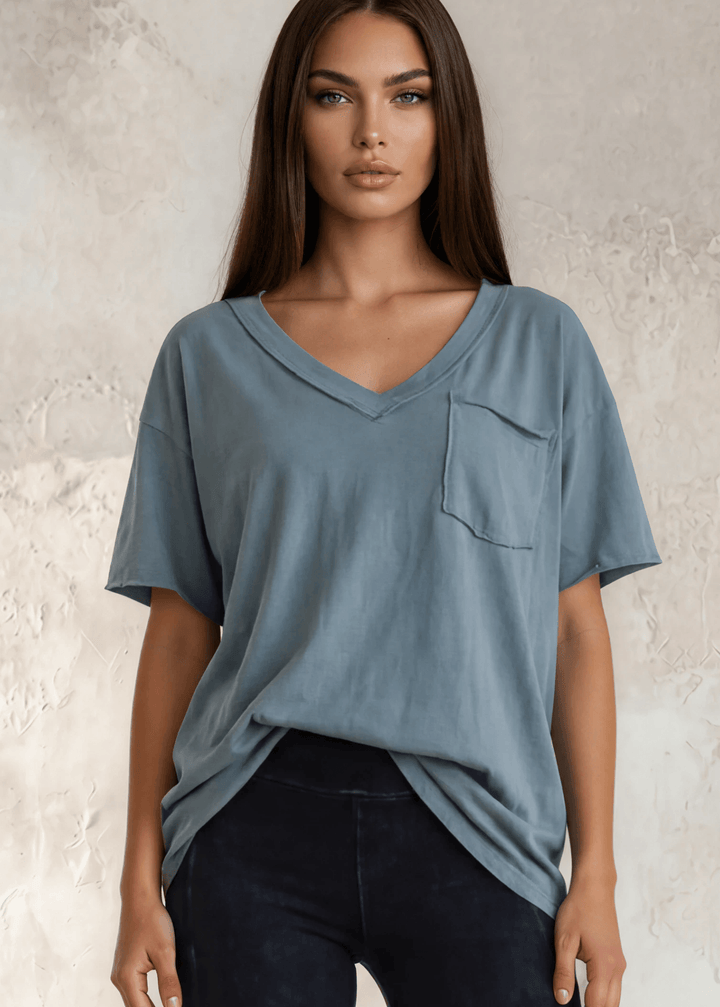 This Made in USA Slate Blue T-Shirt offers a relaxed fit made from soft, 100% cotton medium-weight fabric that is garment washed for lasting comfort. Featuring a raw edge detail and a convenient front pocket, this short-sleeve tee is perfect for everyday wear.