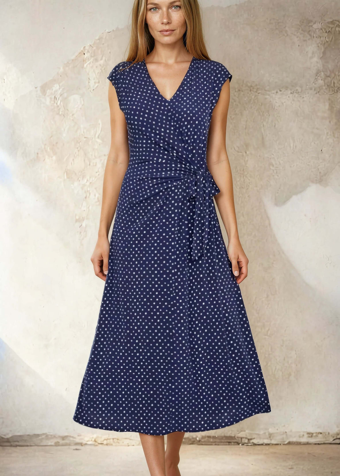 USA-made women's navy polka dot midi dress with a side-tie waist & flared skirt. Cap sleeves, V-neck, sizes S–XL