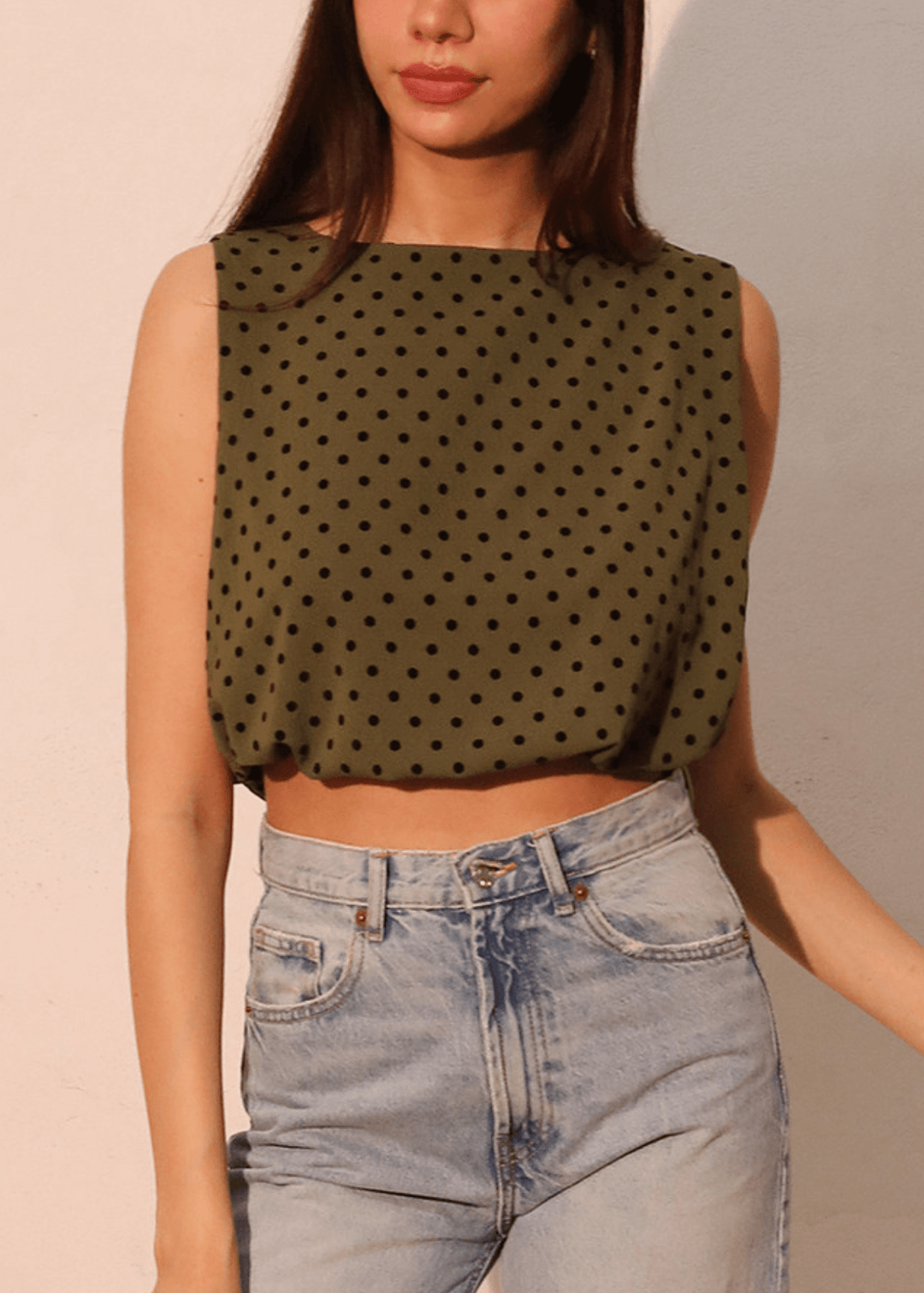 Elevate your casual wardrobe with this charming Flocked Polka Dot Bubble Crop Top. Crafted in USA from luxurious flocked satin in dark olive green with contrasting black dots, this sleeveless style features a soft elastic hem for a comfortable, flattering fit.