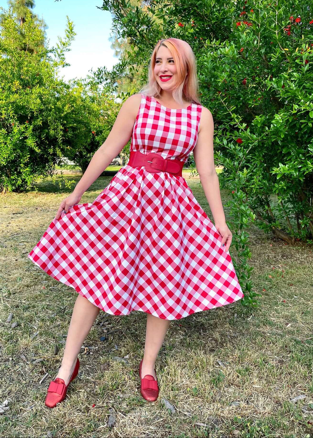 Made in USA Women's vintage style piece with fun, modern details; our midi dress is now available in our adorable red gingham. Made from 100% cotton, this classic 1950's inspired dress features a high neckline, longer length swing skirt with hidden side pockets, and back zippered closure.