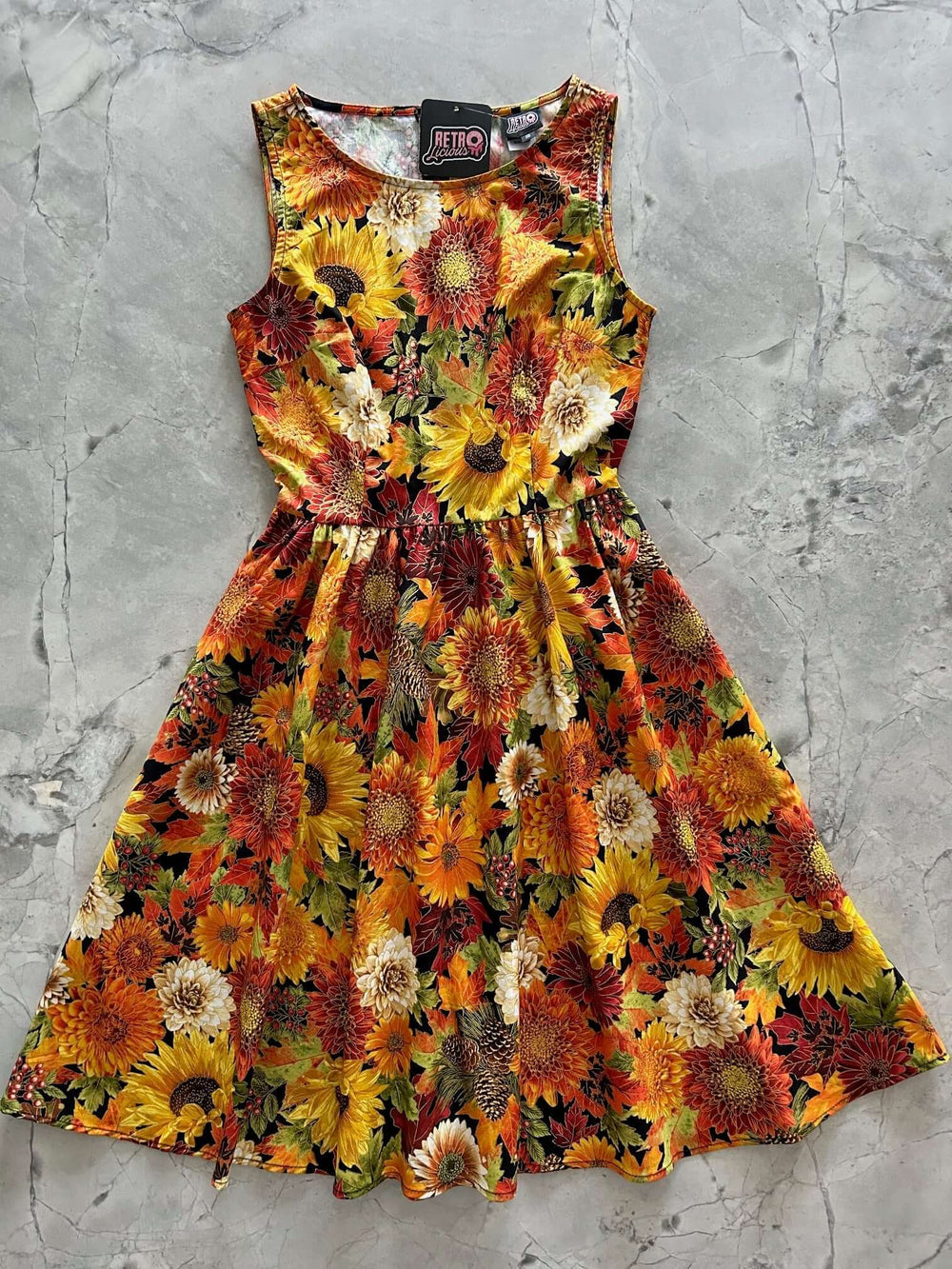 Made in USS Women's vintage style piece with fun, modern details in our Sunflower Floral print. Made from 100% cotton, this classic 1950's inspired dress features a high neckline, longer length skirt with hidden side pockets and back zippered closure.