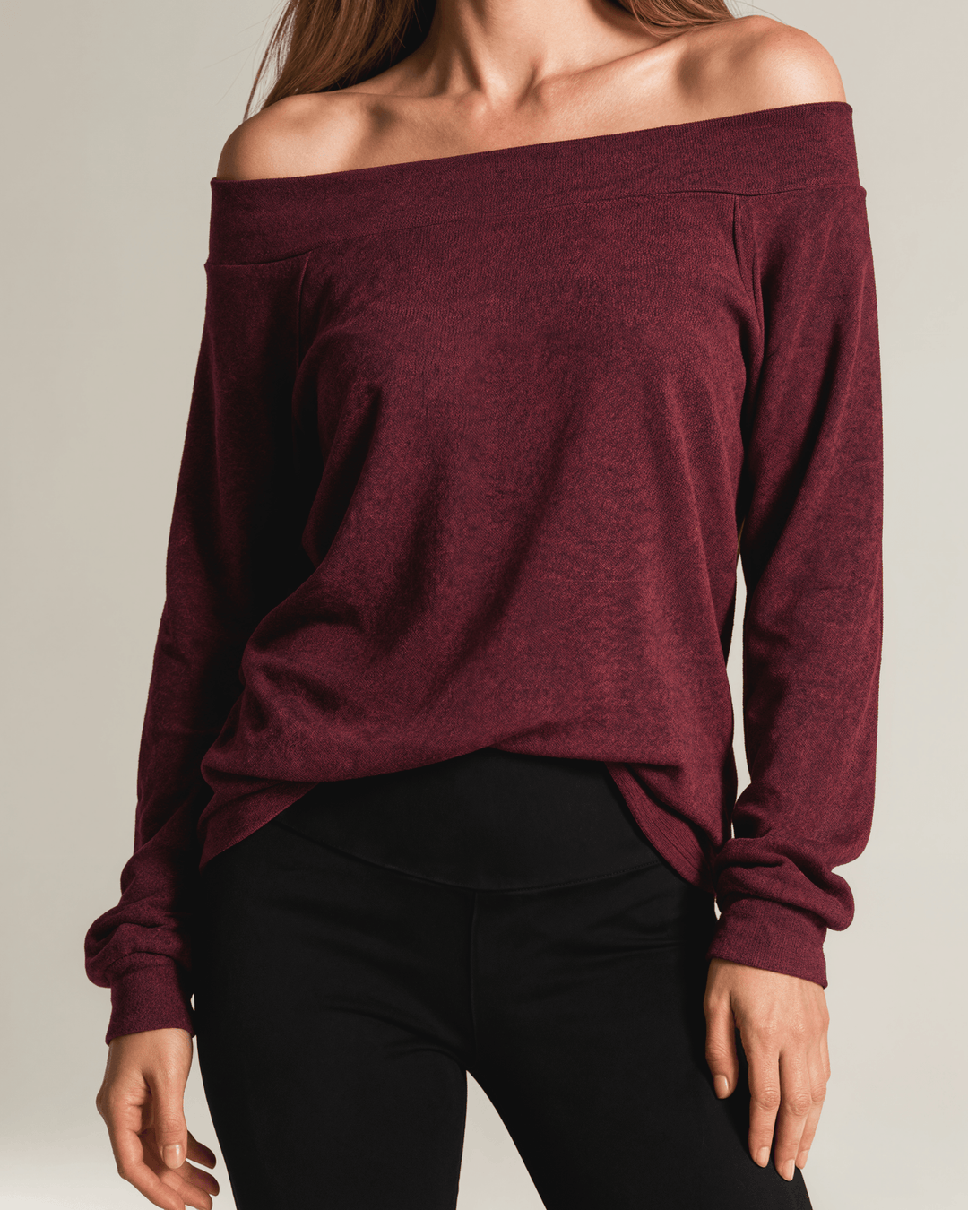 Made in USA burgundy heather off-the-shoulder knit top with raw edge seams, banded cuffs and hem, and a relaxed slouchy fit.