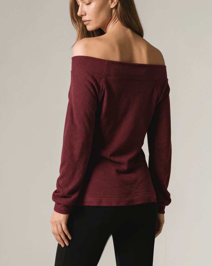 Made in USA burgundy heather off-the-shoulder knit top with raw edge seams, banded cuffs and hem, and a relaxed slouchy fit.