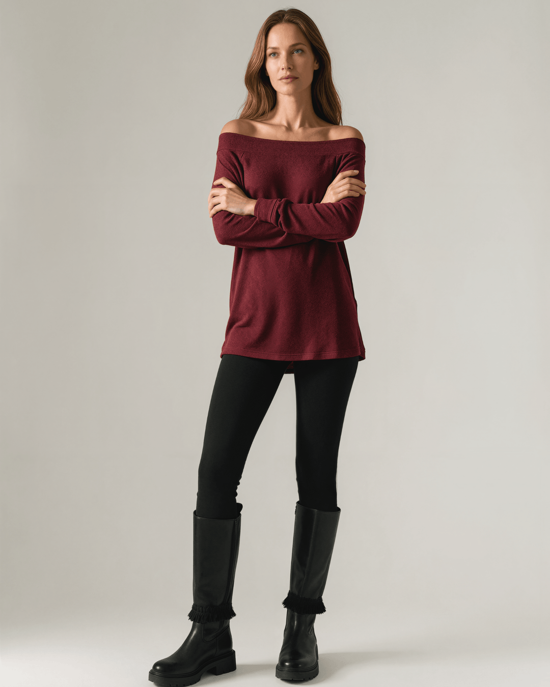 Made in USA burgundy heather off-the-shoulder knit top with raw edge seams, banded cuffs and hem, and a relaxed slouchy fit.