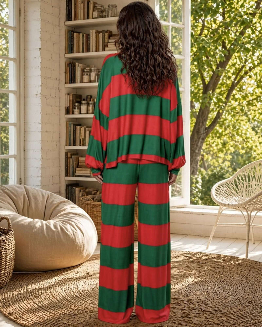 Made in USA women’s festive Christmas pajama set with bold red and deep green horizontal stripes, a loose-fitting long-sleeve crewneck top with dropped shoulders and cuffed sleeves, and matching flowing drawstring pants with gently flared legs.

