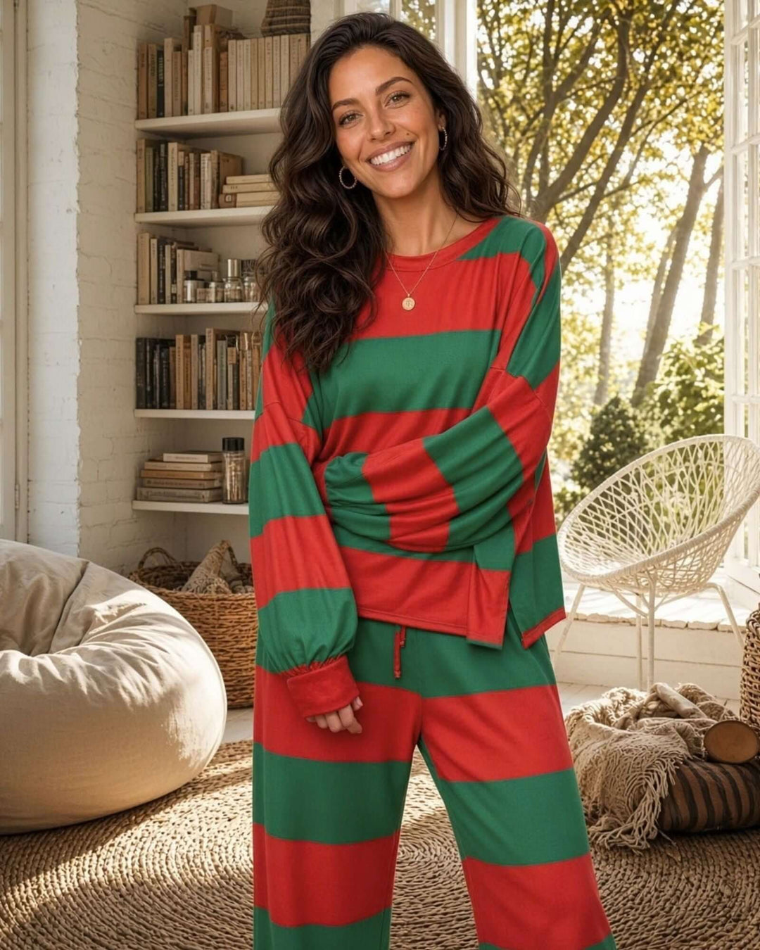 Made in USA women’s festive Christmas pajama set with bold red and deep green horizontal stripes, a loose-fitting long-sleeve crewneck top with dropped shoulders and cuffed sleeves, and matching flowing drawstring pants with gently flared legs.

