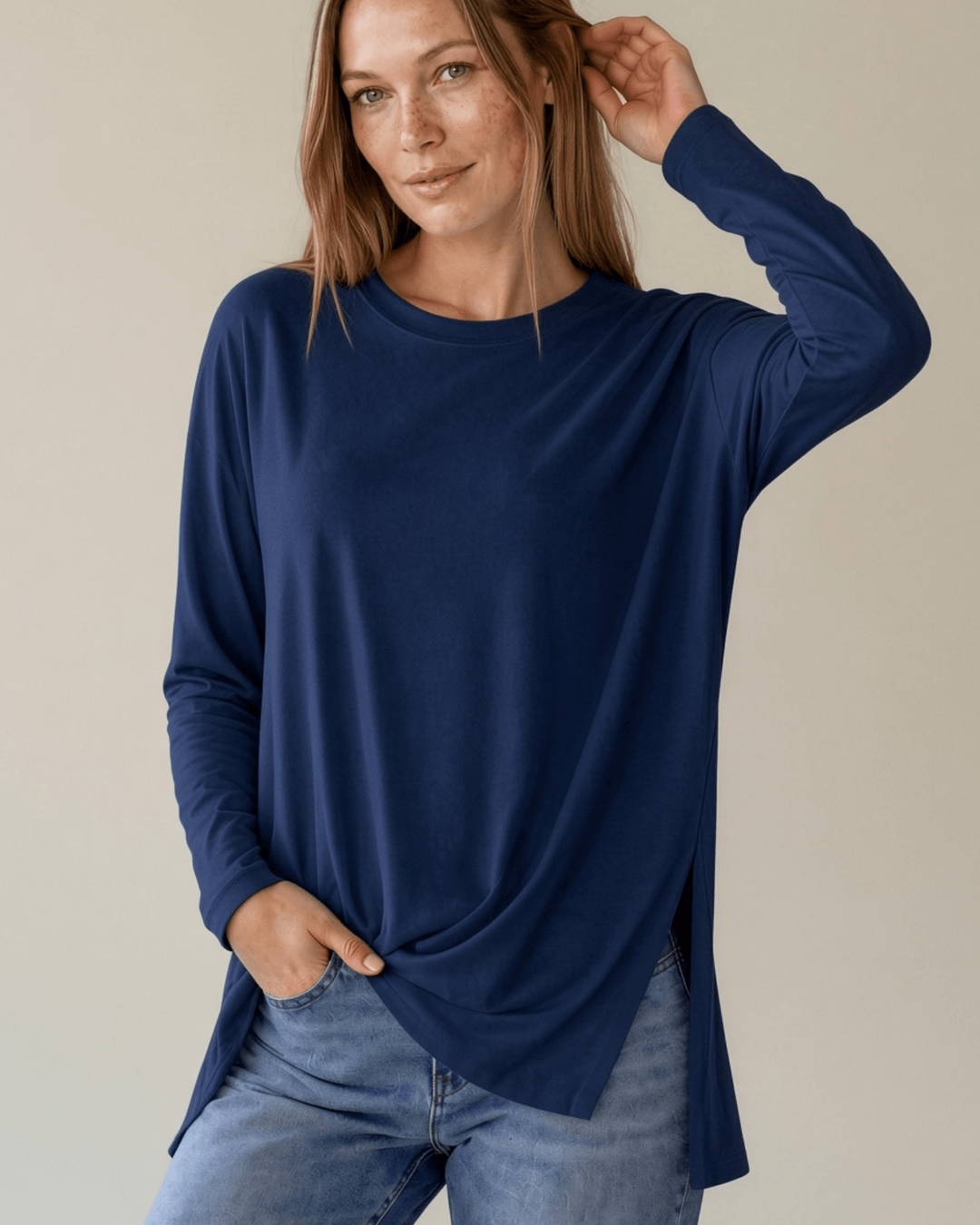 Made in USA. Women's navy blue long sleeve cotton top with a crew neck, relaxed fit and side slits. Soft 95% cotton with stretch for easy everyday layering.