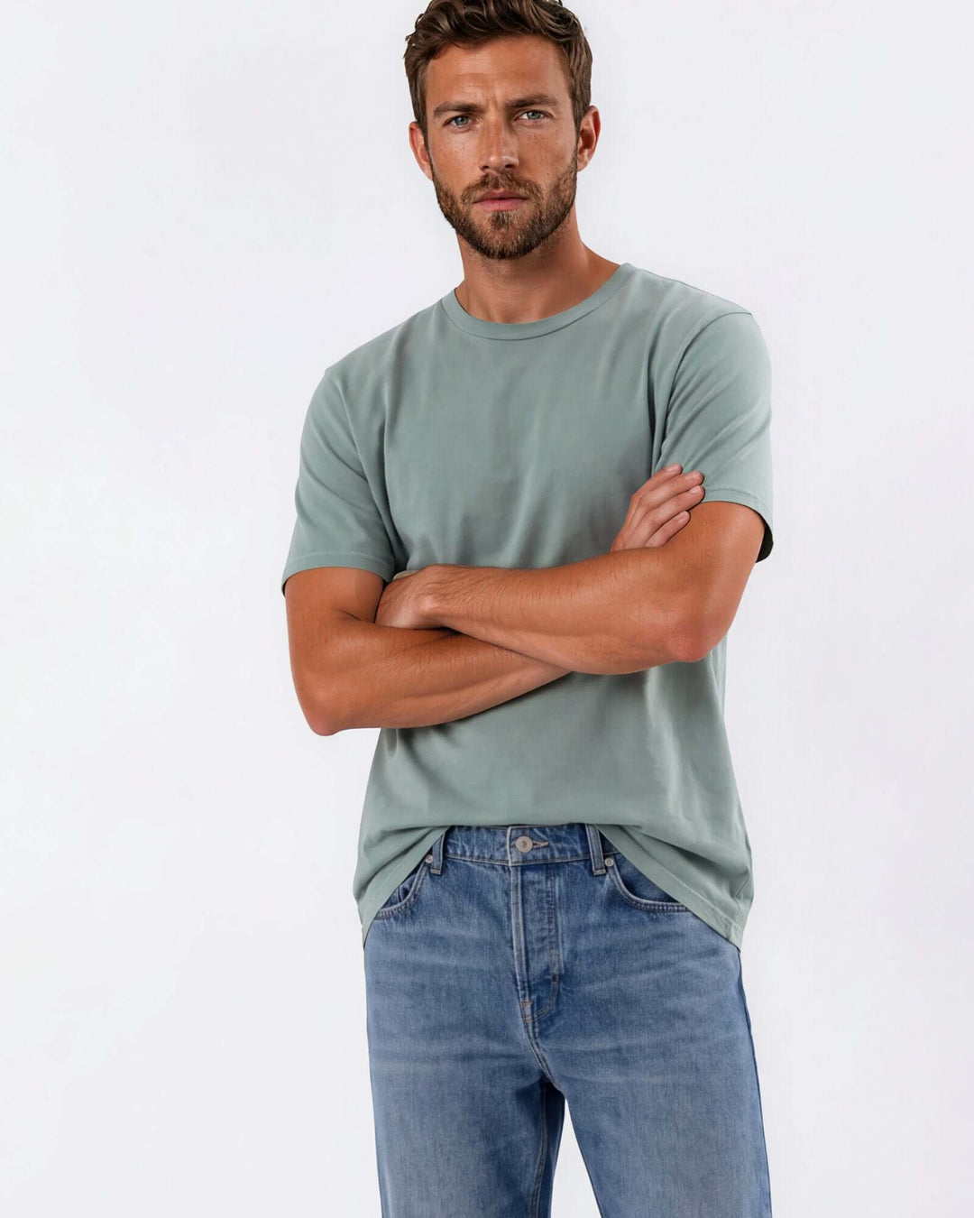 Made in USA Vintage Pigment Dyed Softest Tee - Fern: sage green crew neck tee on male model with arms crossed
