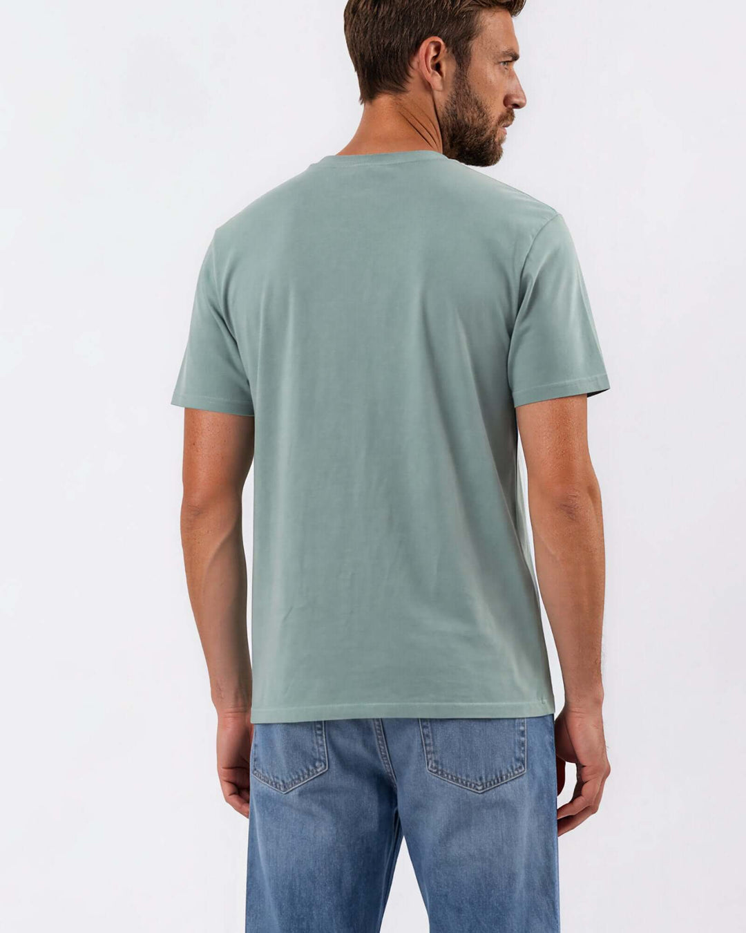 Made in USA Vintage Pigment Dyed Softest Tee - Fern: back view of sage green short sleeve tee on male model with jeans