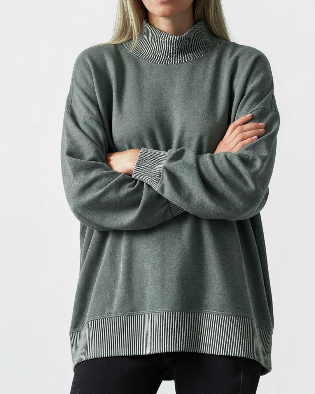 Made in USA women's sage green oversized mock neck fleece sweatshirt with collar side slit, ribbed trim, and dropped shoulders, front view, arms crossed