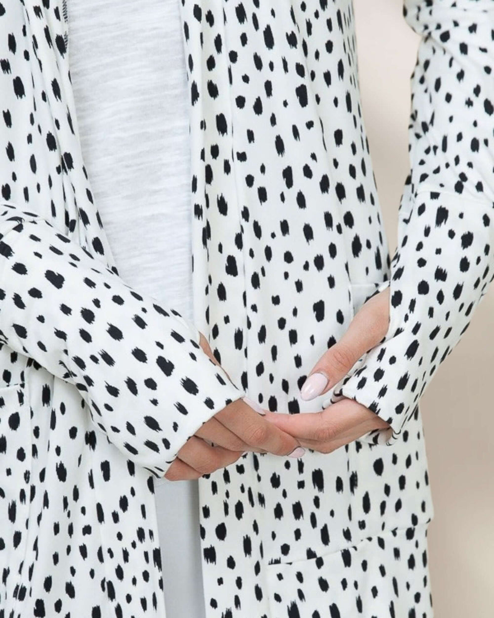 Made in USA Dolly Dot Print Cardigan: close-up detail of black dot print and thumbhole sleeve cuff