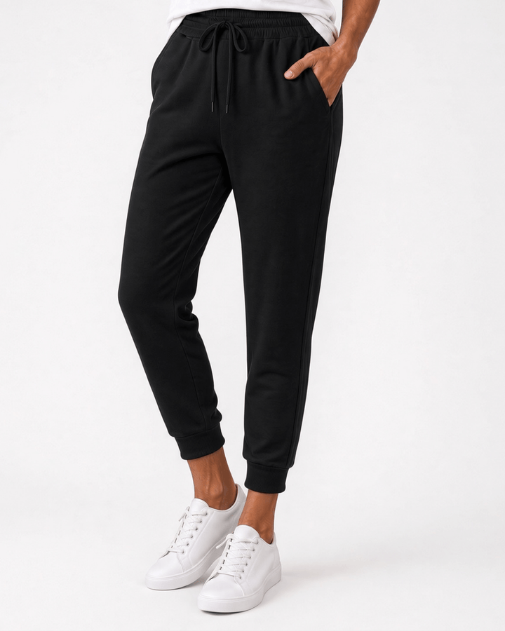 Made in USA, these black cropped joggers blend 62% cotton and 38% polyester, with a relaxed fit, pockets, and cuffed hems. Sizes S–L.