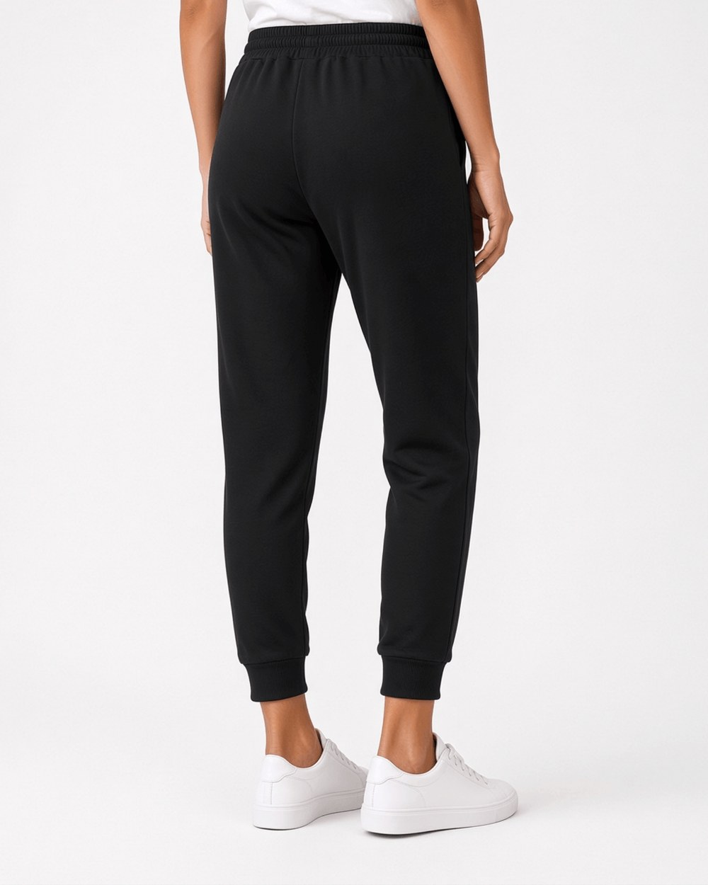 Made in USA, these black cropped joggers blend 62% cotton and 38% polyester, with a relaxed fit, pockets, and cuffed hems. Sizes S–L.