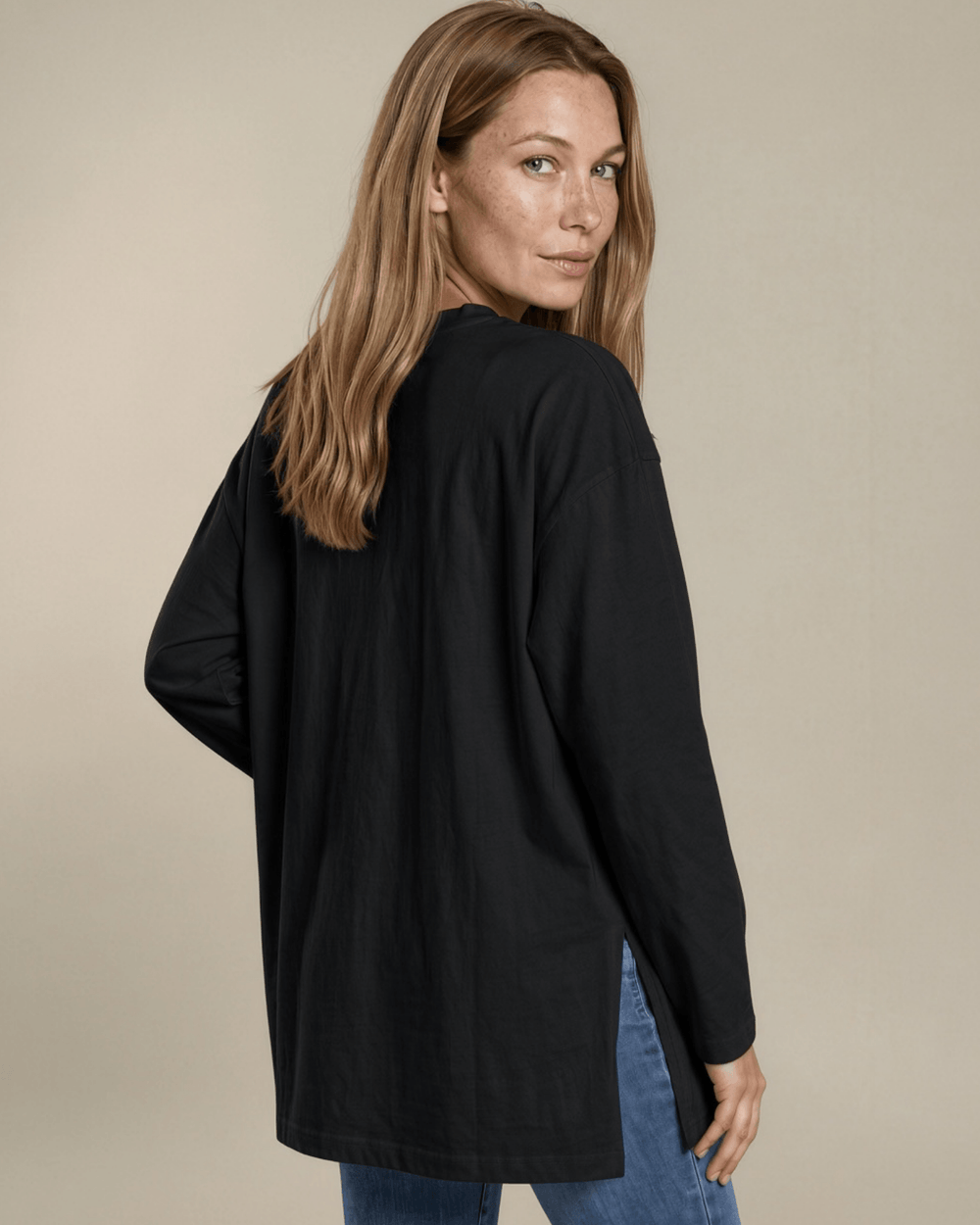 Made in USA. Women's black long sleeve cotton top with a crew neck, relaxed fit and side slits. Soft 95% cotton with stretch for easy everyday layering.