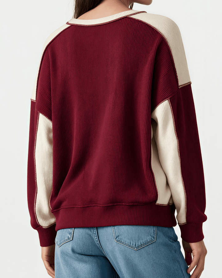 Made in USA. Burgundy &amp; cream color block ribbed knit sweatshirt. Notched neck, exposed seams, oversized fit. 97% polyester. Sizes S–XL.