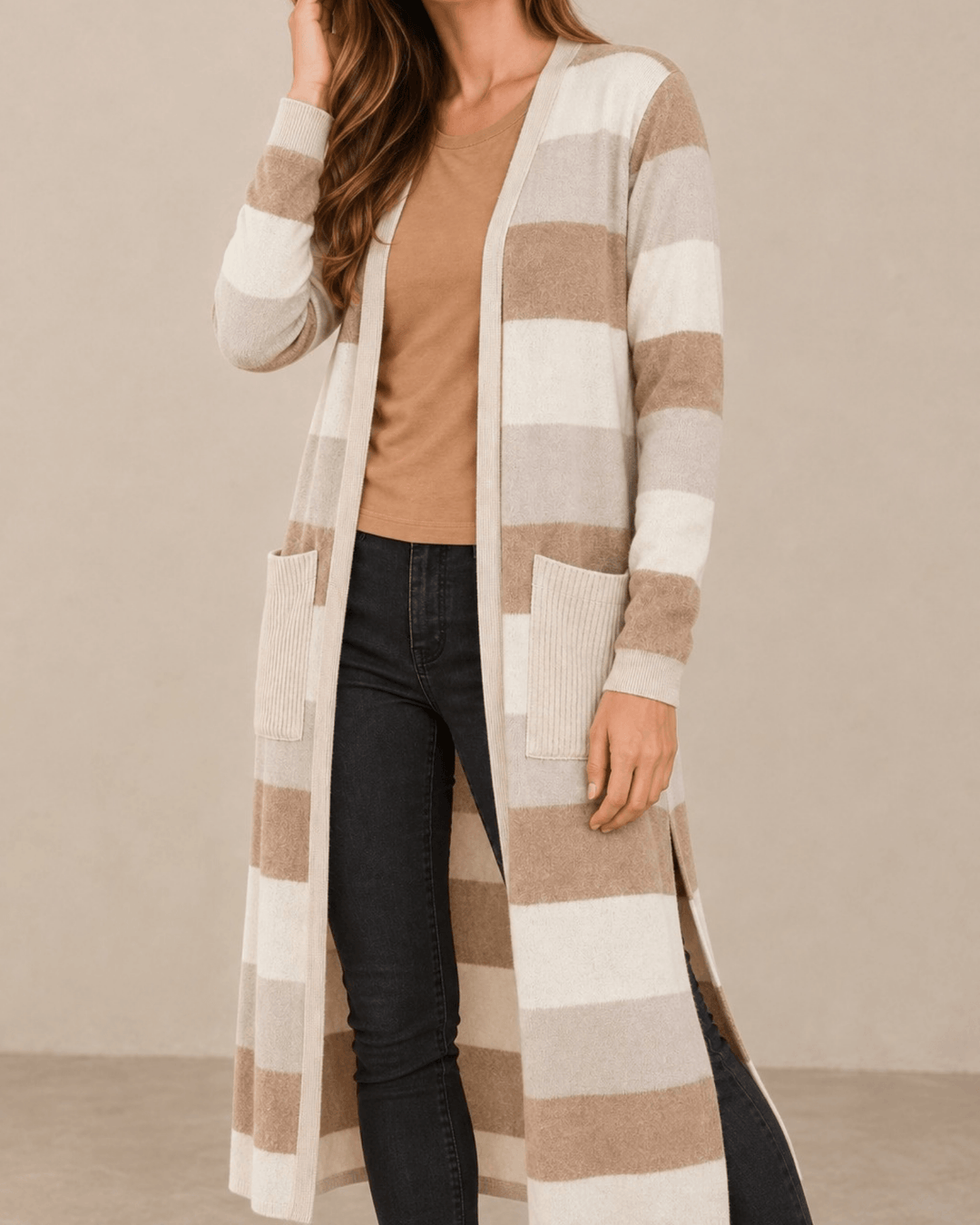 Woman wearing Made in USA the Lilian taupe striped longline cardigan with an open front, long sleeves, patch pockets and side slits for easy everyday layering.