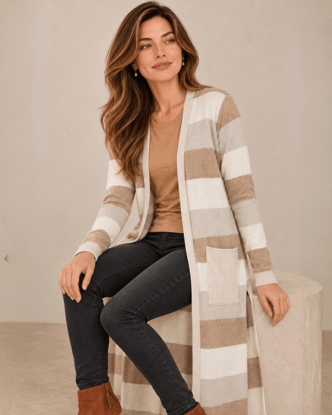Woman wearing Made in USA the Lilian taupe striped longline cardigan with an open front, long sleeves, patch pockets and side slits for easy everyday layering.