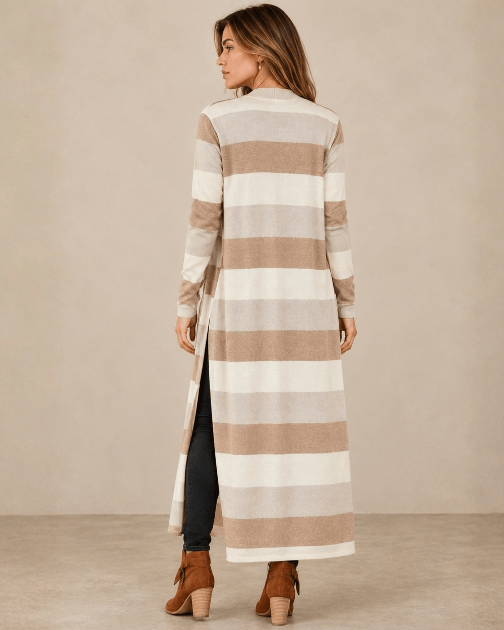 Woman wearing Made in USA the Lilian taupe striped longline cardigan with an open front, long sleeves, patch pockets and side slits for easy everyday layering.