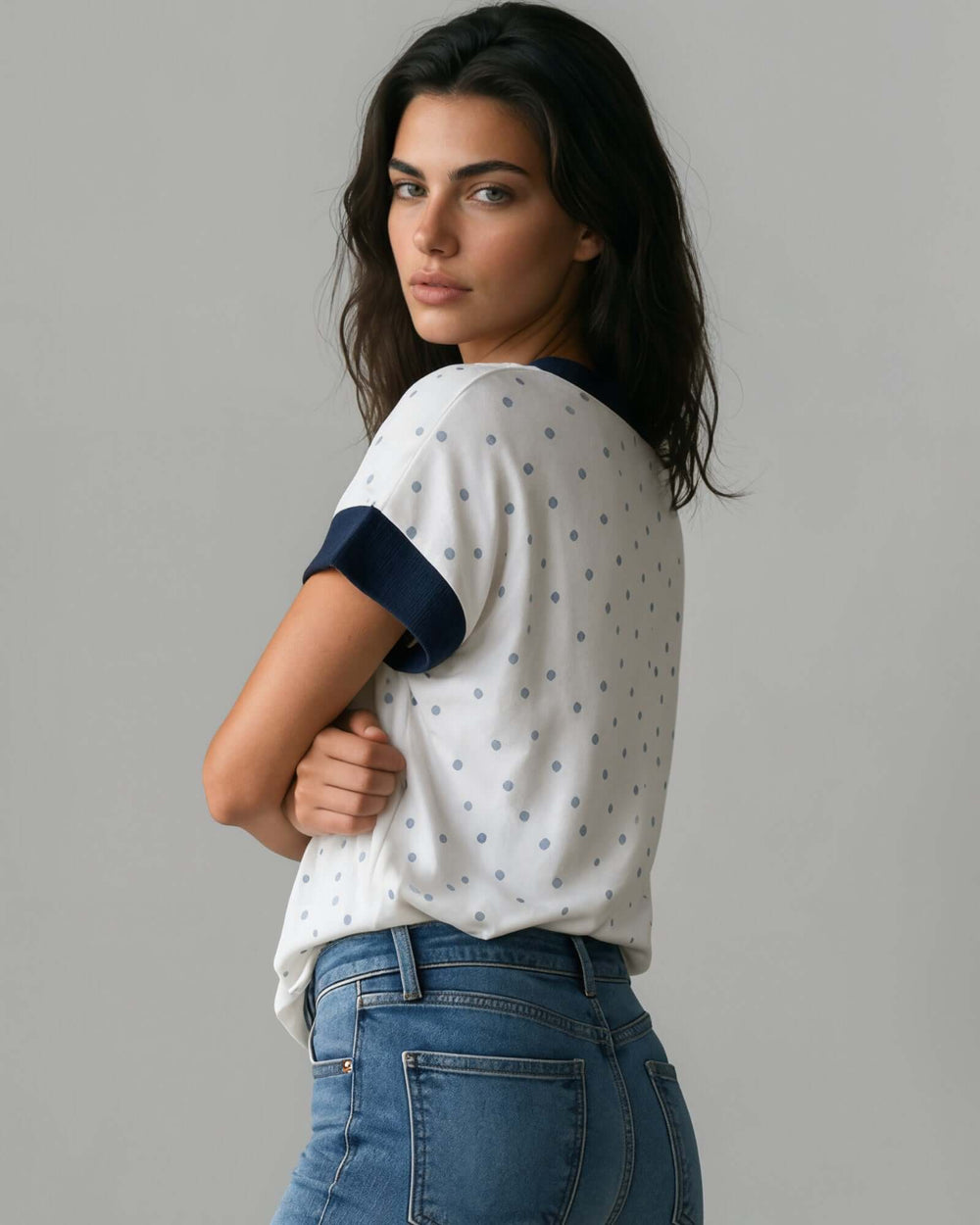 Made in USA women's white and navy polka dot split V-neck short sleeve top with navy contrast trim, side view