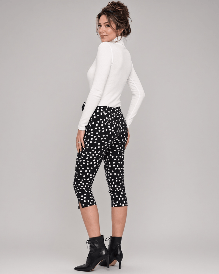 Made in USA. Polly black and white polka dot capri pants feature cotton-rich stretch, a bow waist tie and side-slit hems. A playful statement pair! Style 5460PT by Renee C