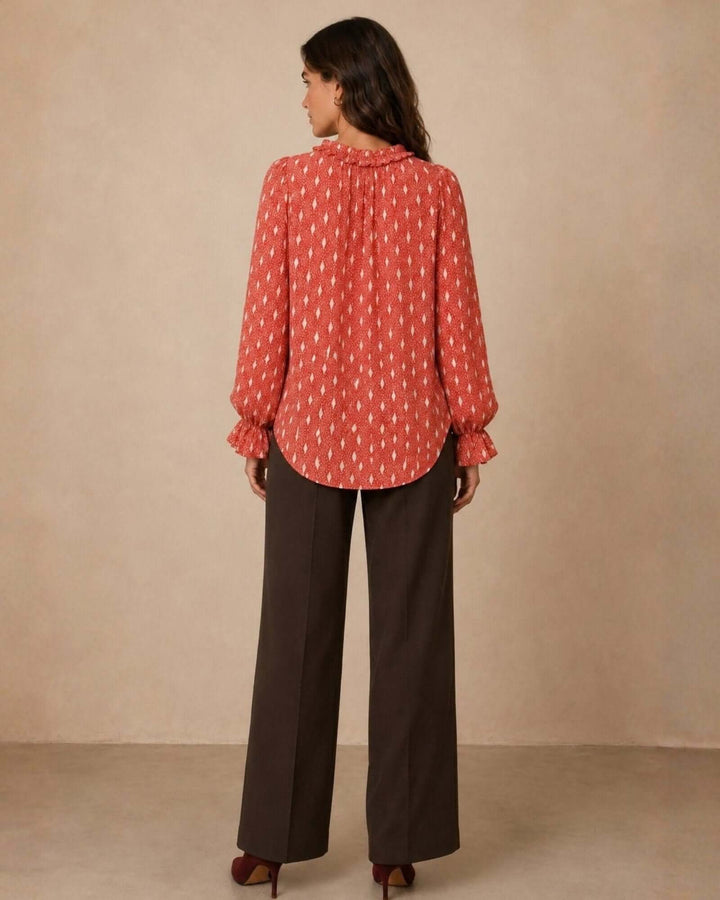 Made in USA Radiant Ruffle Neck Foil Print Blouse - Red: full-length back view with dark brown trousers