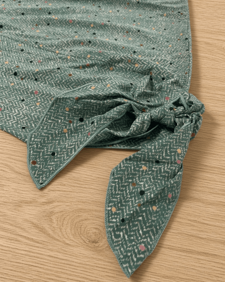 Made in USA. Green confetti dot chevron blouse with a V-neck, dolman sleeves and adjustable cuff ties. Lightweight woven fabric with a loose, flowing fit.