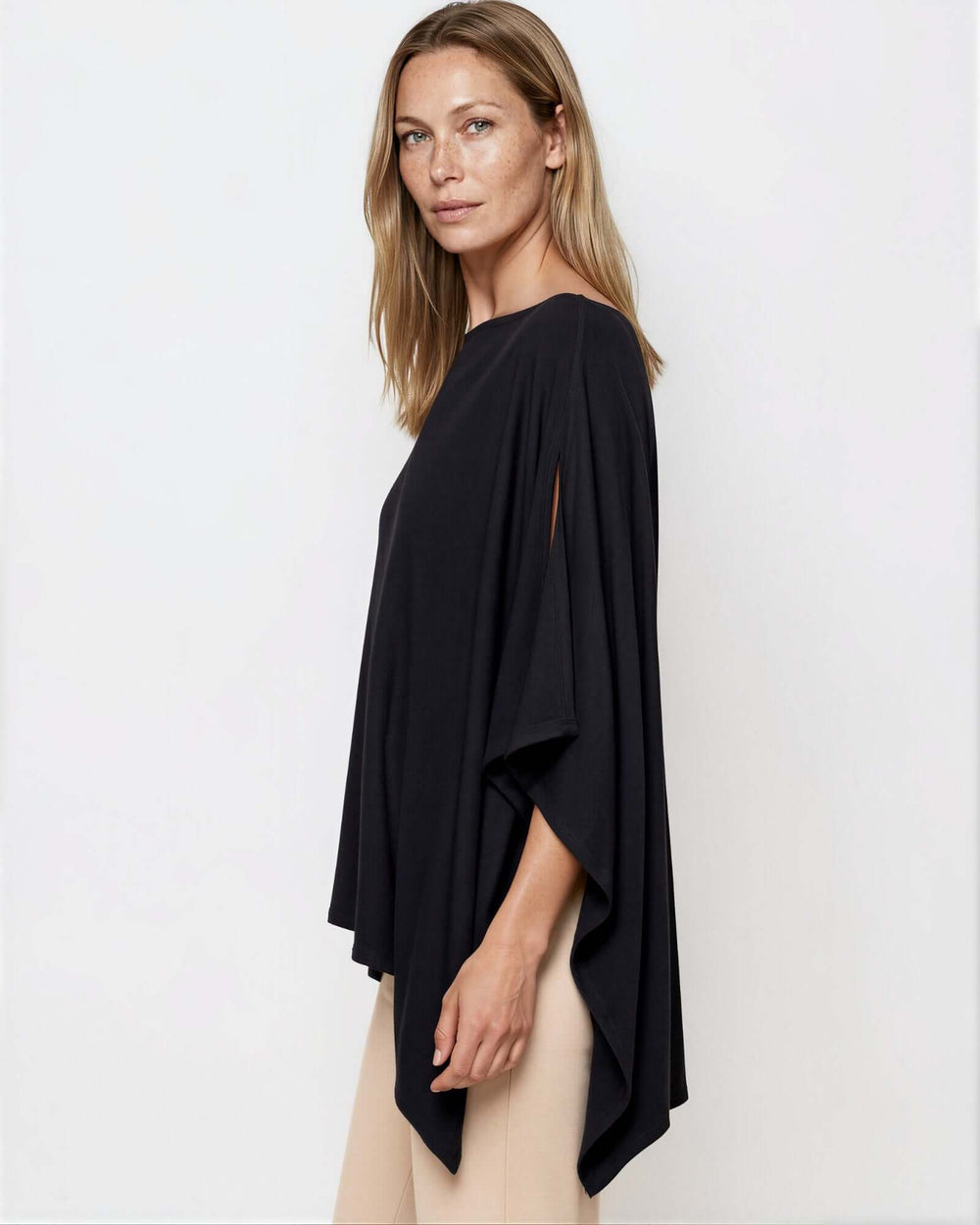 Made in USA Asymmetrical Boat Neck Poncho Top - Black: side profile showing long draped side