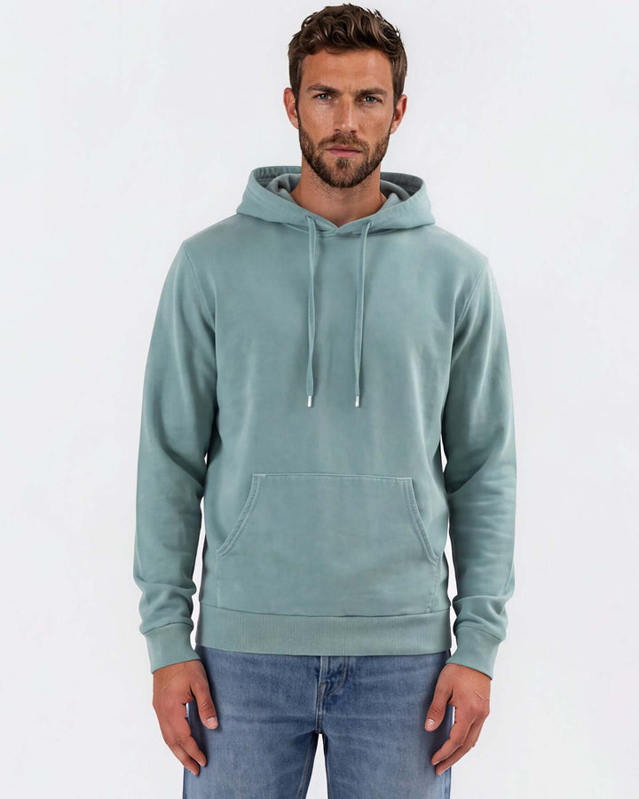 Made in USA vintage pigment dyed fleece pullover hoodie in Fern with drawstring hood, front pouch pocket, and ribbed cuffs and hem - front view
