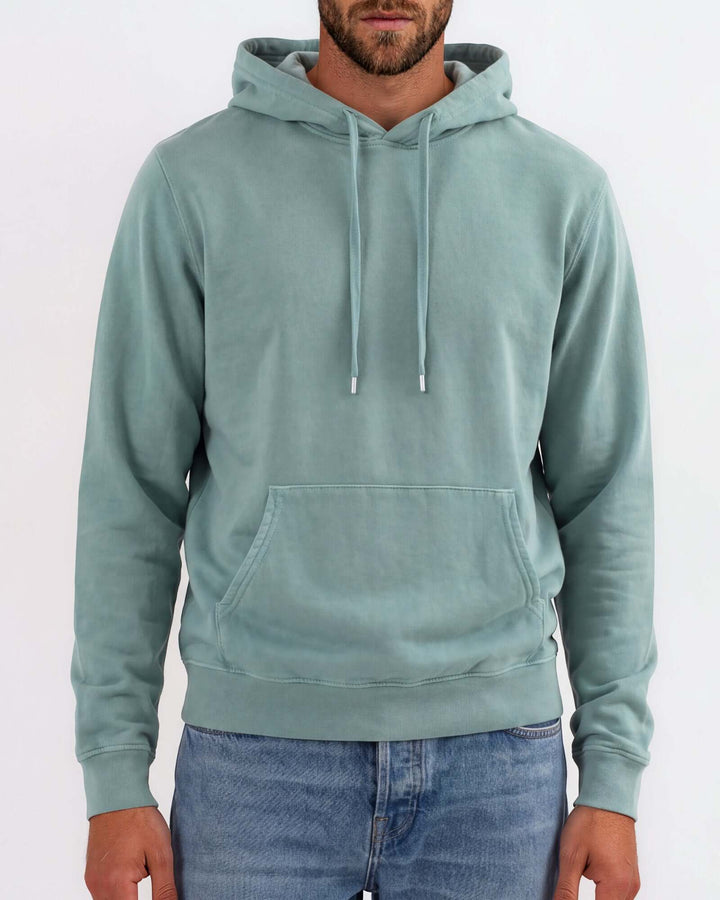 Made in USA vintage pigment dyed fleece pullover hoodie in Fern with drawstring hood, front pouch pocket, and ribbed cuffs and hem