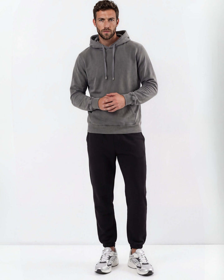 Made in USA vintage pigment dyed fleece pullover hoodie in Charcoal with drawstring hood, front pouch pocket, and ribbed cuffs and hem