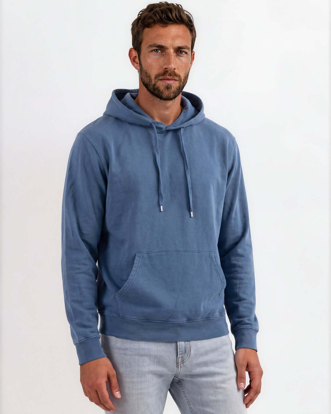 Made in USA vintage pigment dyed fleece pullover hoodie in Blue Steel with drawstring hood, front pouch pocket, and ribbed cuffs and hem - front view