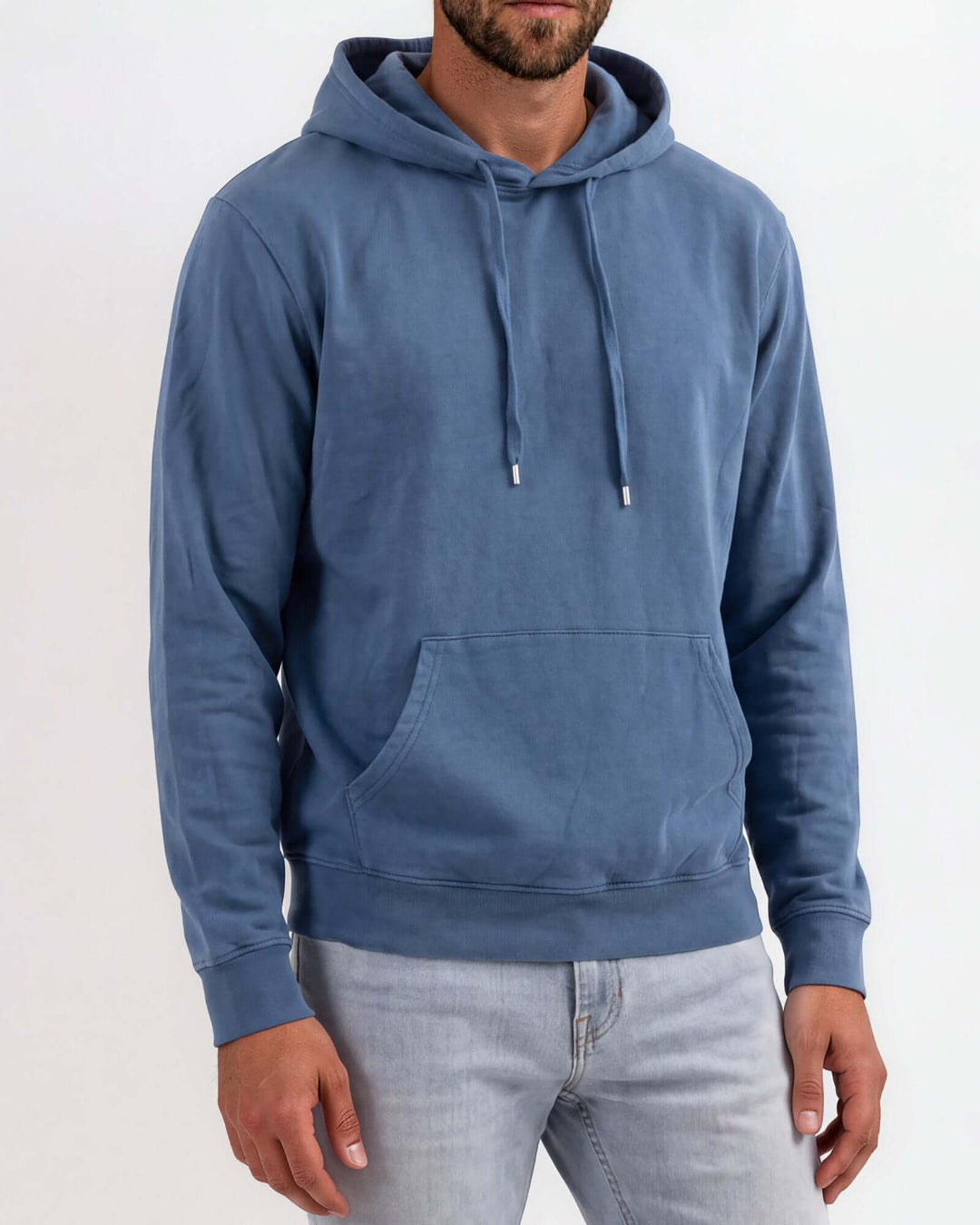 Made in USA vintage pigment dyed fleece pullover hoodie in Blue Steel with drawstring hood, front pouch pocket, and ribbed cuffs and hem