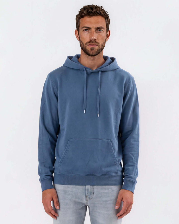 Made in USA vintage pigment dyed fleece pullover hoodie in Blue Steel with drawstring hood, front pouch pocket, and ribbed cuffs and hem