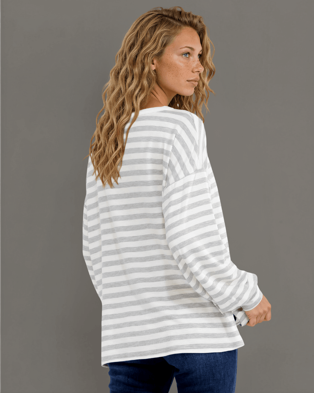 Made in USA. Grey & white striped lightweight oversized pullover. Split V-neck, dropped shoulder, side slits. 68% rayon. Sizes S–XL.