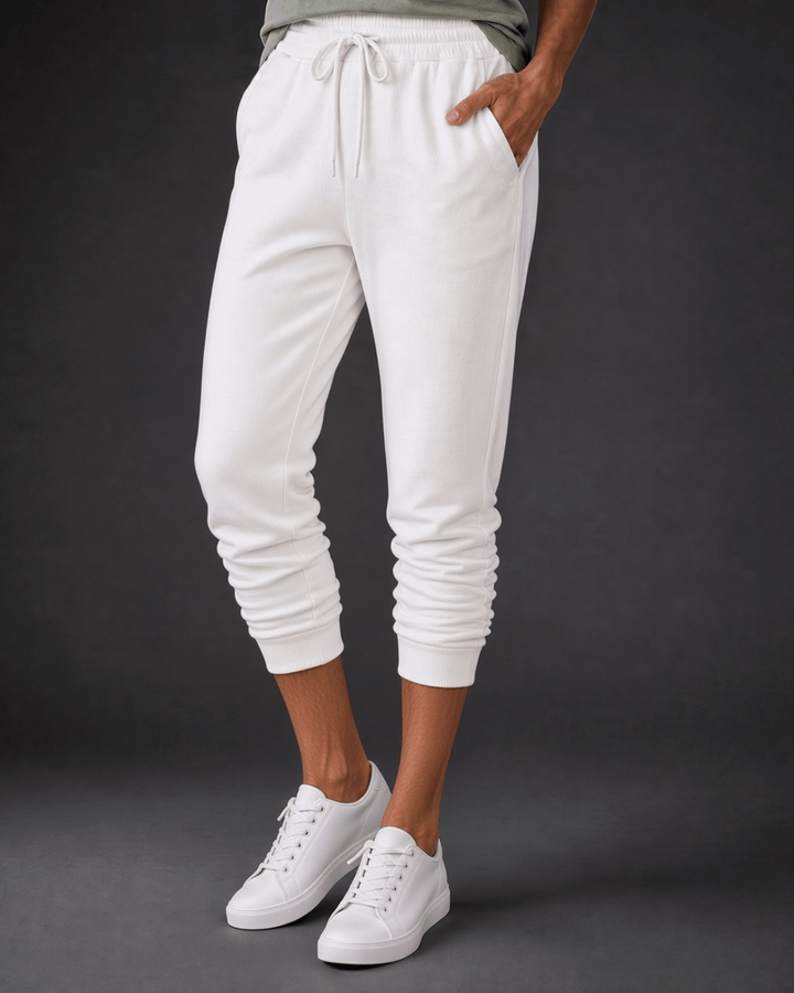 Made in USA, these white cropped joggers blend 62% cotton and 38% polyester, with a relaxed fit, pockets, and cuffed hems. Sizes S–L.