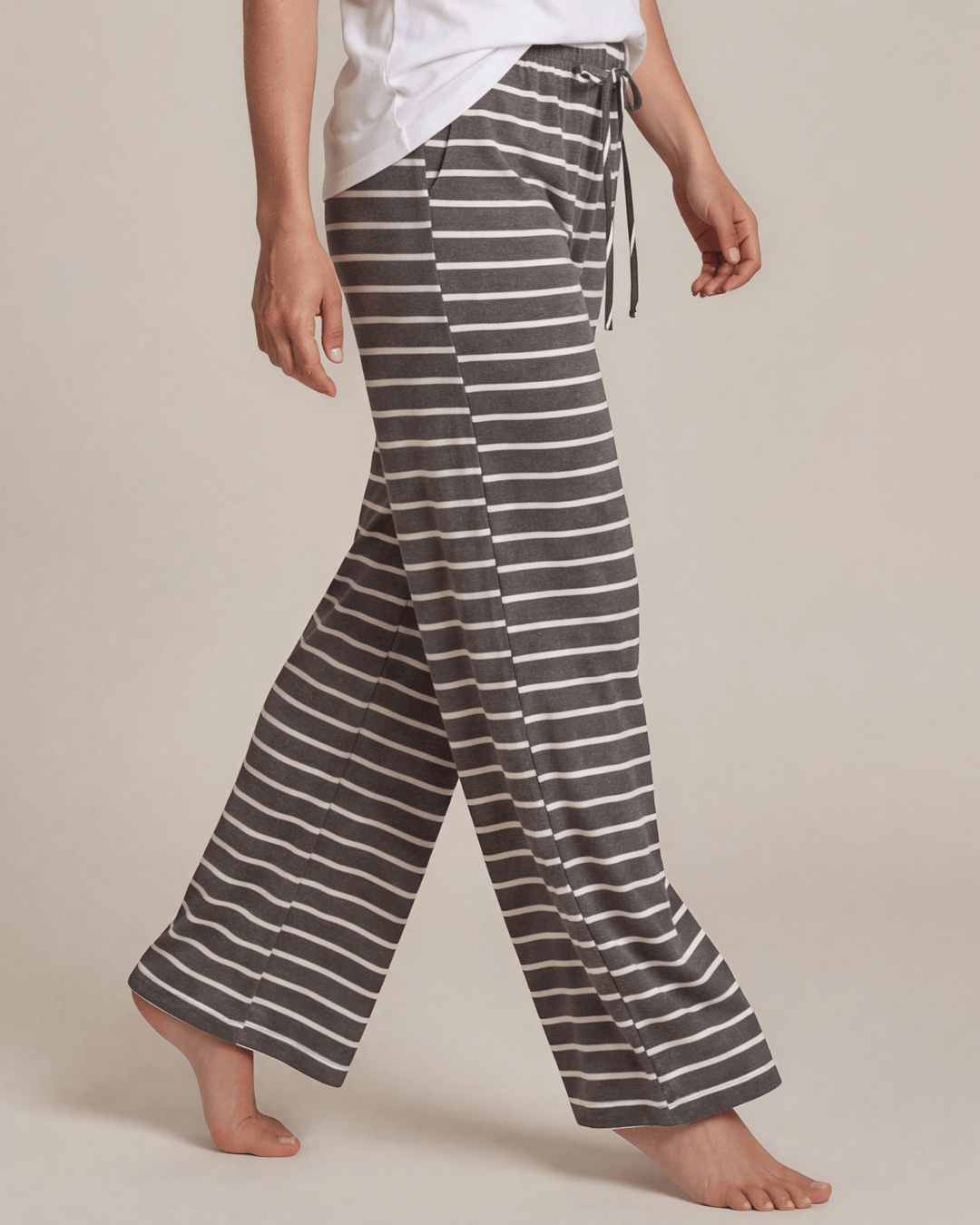 Made in USA. Relax in charcoal striped wide-leg pajama pants with an elastic drawstring waist, side pockets and soft stretch fabric. Sizes S–XL.