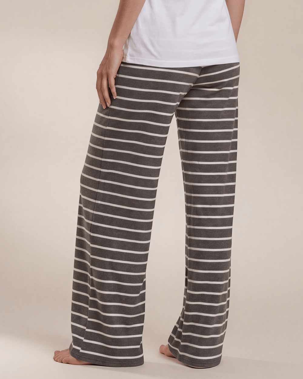 Made in USA. Relax in charcoal striped wide-leg pajama pants with an elastic drawstring waist, side pockets and soft stretch fabric. Sizes S–XL.