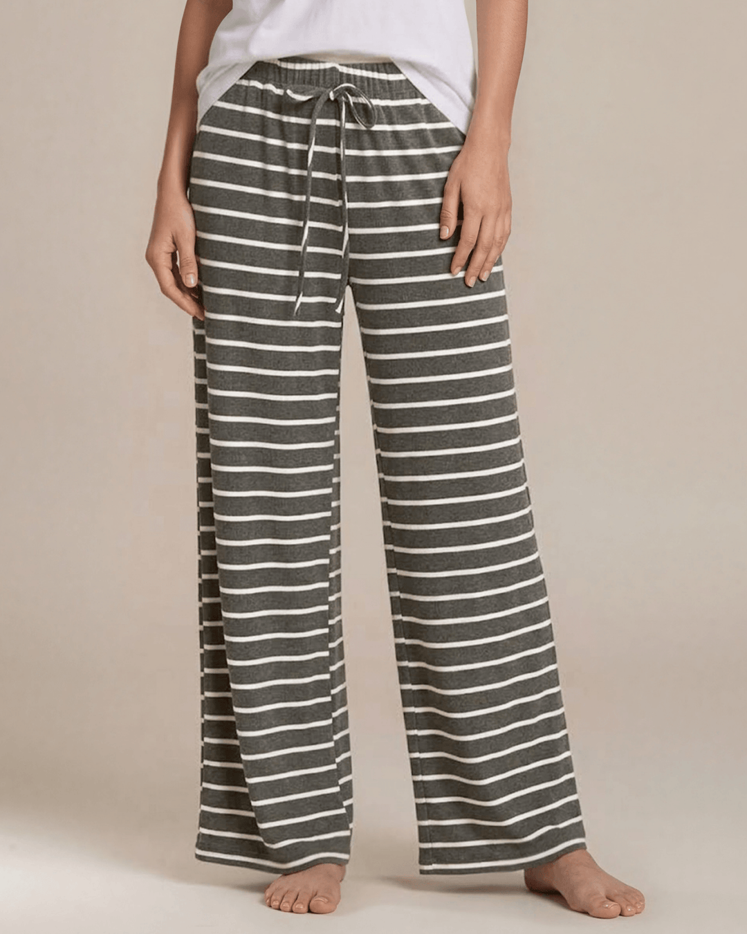 Made in USA. Relax in charcoal striped wide-leg pajama pants with an elastic drawstring waist, side pockets and soft stretch fabric. Sizes S–XL.