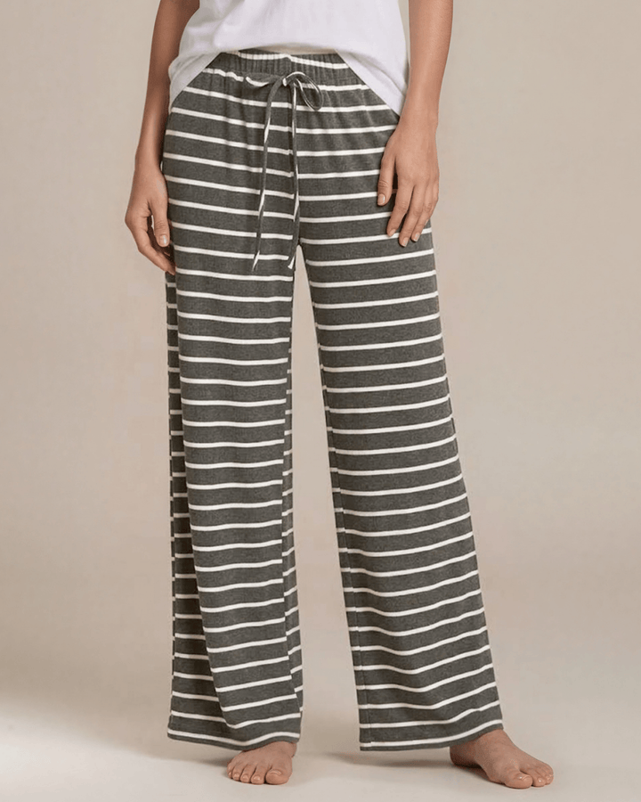 Made in USA. Relax in charcoal striped wide-leg pajama pants with an elastic drawstring waist, side pockets and soft stretch fabric. Sizes S–XL.