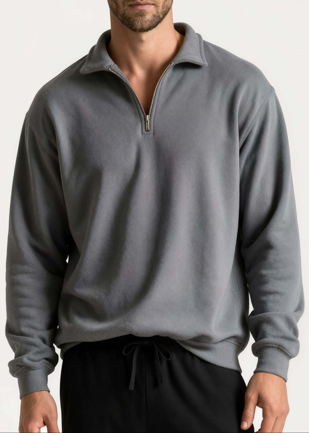 Made in USA men's cotton True American grey quarter-zip pullover with a stand collar, long sleeves, ribbed cuffs and hem, shown on a male model.