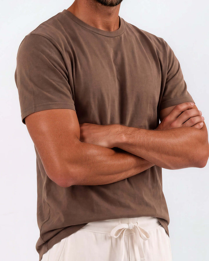 Made in USA Vintage Pigment Dyed Softest Tee - Java: brown crew neck tee close-up on model with arms crossed