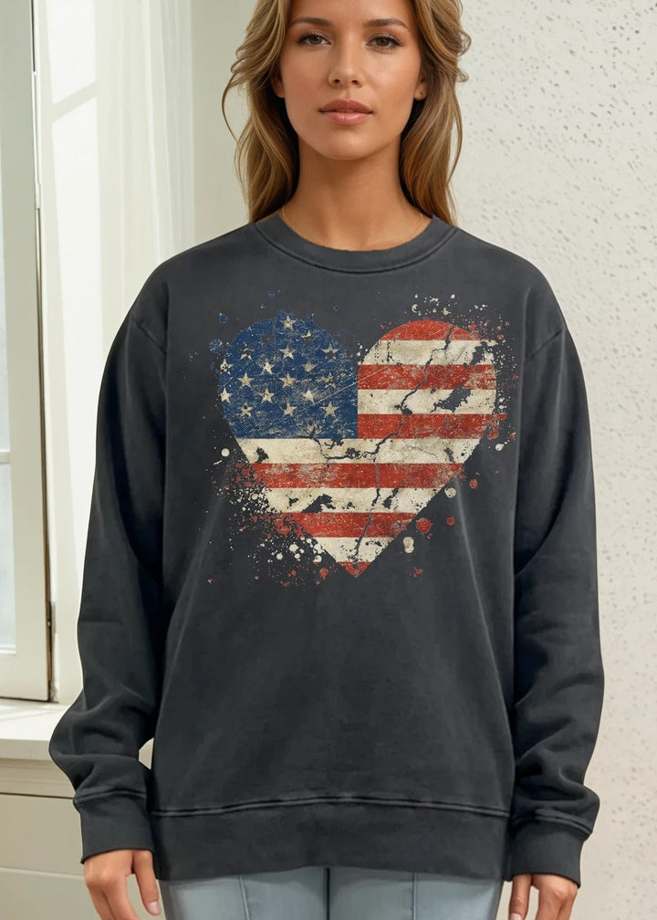 Celebrate American pride with this heavyweight sweatshirt, featuring a distressed flag heart graphic on pigment-dyed cotton fleece. The relaxed crew neck silhouette and long sleeves deliver comfort through fall and winter months. Crafted from 100% preshrunk cotton and made in the USA, this piece resists fading and maintains its shape wash after wash. 