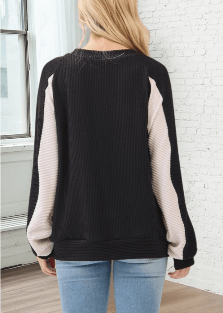 Experience effortless style and comfort with the Hailey Rib Knit Color Block Pullover. Crafted in the USA from a soft, stretchy fabric, Black with Cream contrast