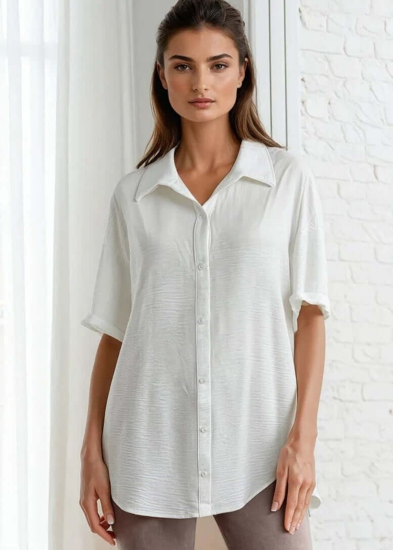 The Julie Oversize Women's Short Sleeve Button Down Shirt in White brings effortless style to your everyday wardrobe. Crafted from a soft, lightweight polyester-spandex blend, this collared button-up features a relaxed oversized fit that works beautifully layered or worn solo. 